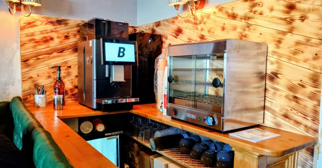 A Blend 2 Vend bean-to-cup coffee machine installed alongside a hot food display unit in a commercial venue