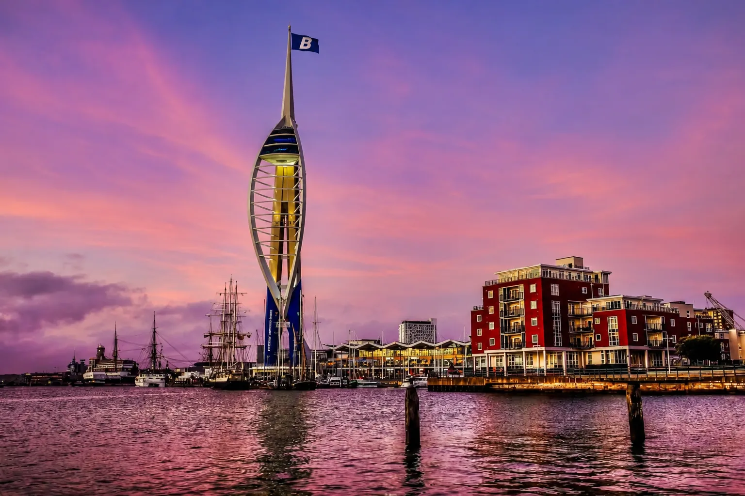 Portsmouth's Spinnaker Tower at sunset flying a Blend 2 Vend flag, with Gunwharf Quays and the harbour waterfront