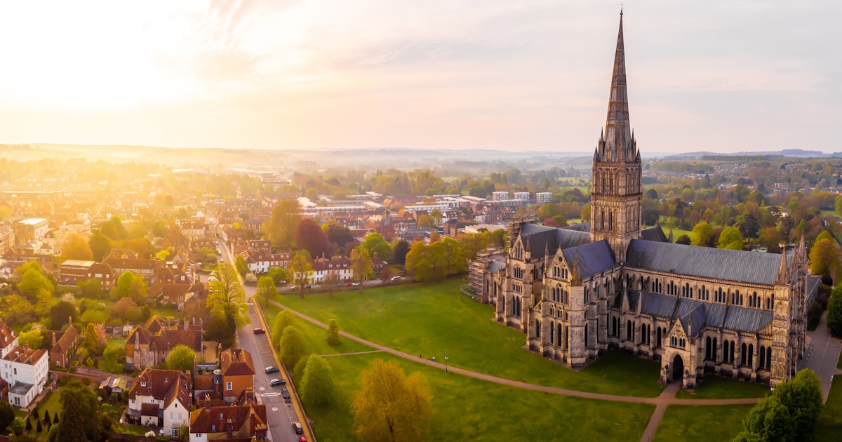 Aerial view of Salisbury Cathedral and the surrounding city at sunrise, Wiltshire